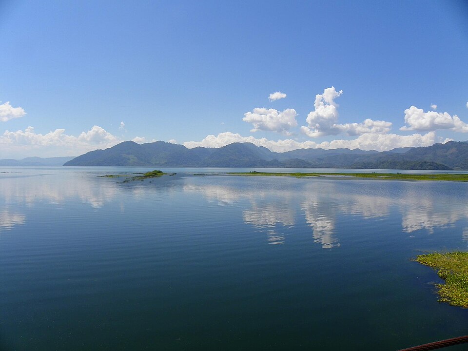 El lago de Yojoa reflejando las nubes, con montañas al fondo