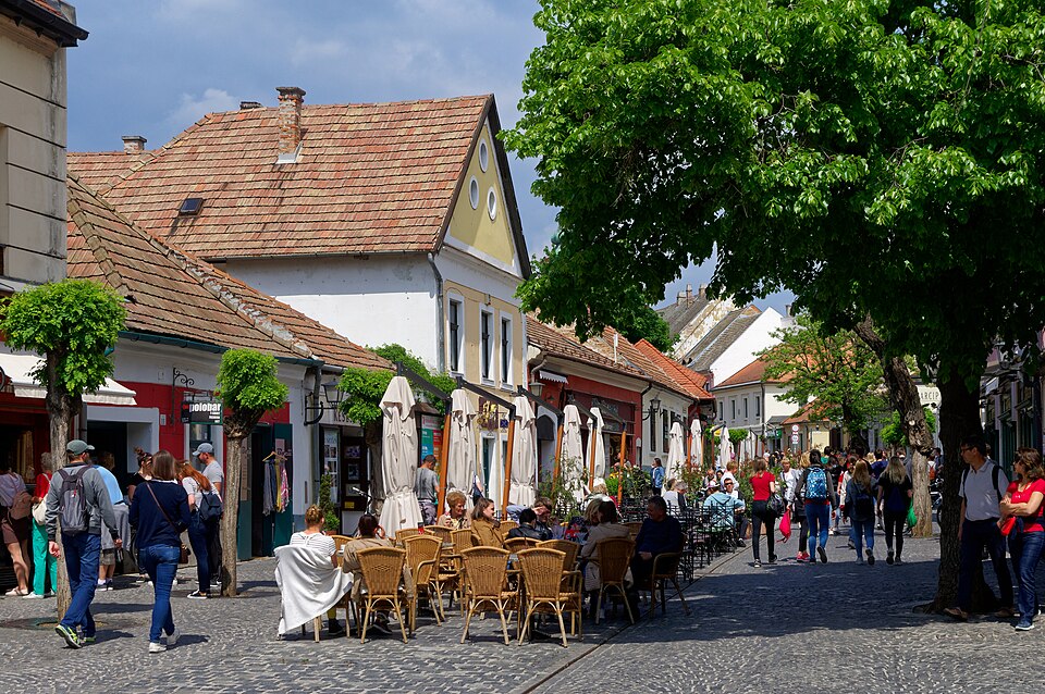 Una calle empedrada con cafés y casas de colores en Szentendre