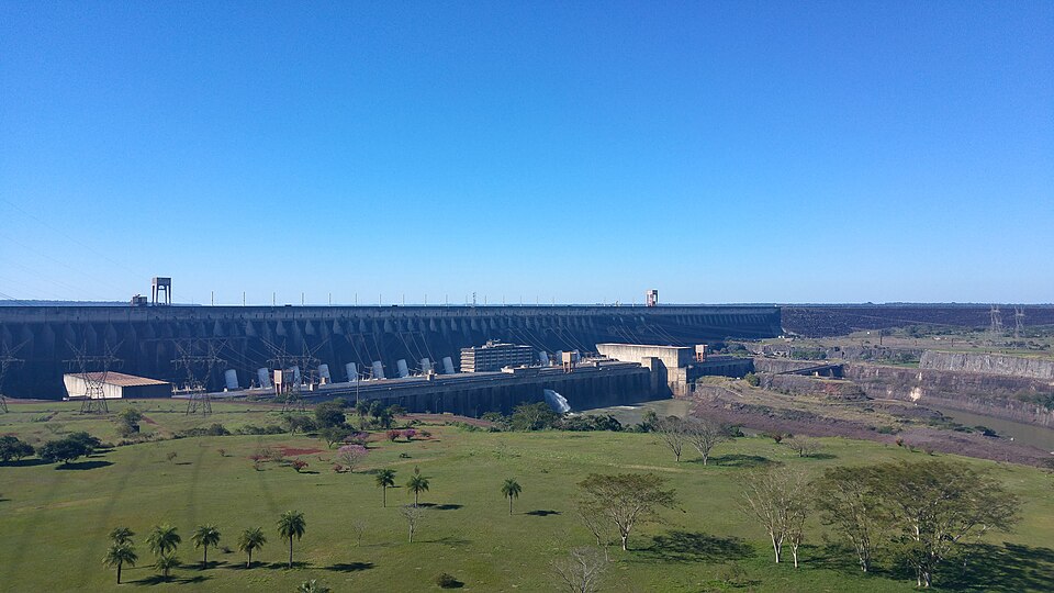 La enorme represa de Itaipú vista desde lejos, sobre un paisaje verde